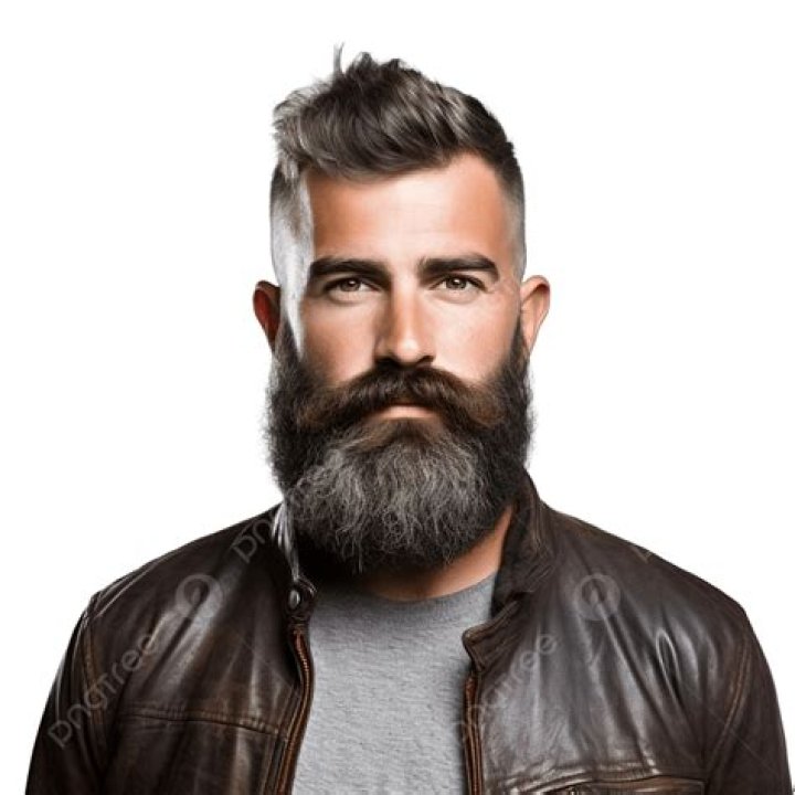 a bearded man with his arms crossed