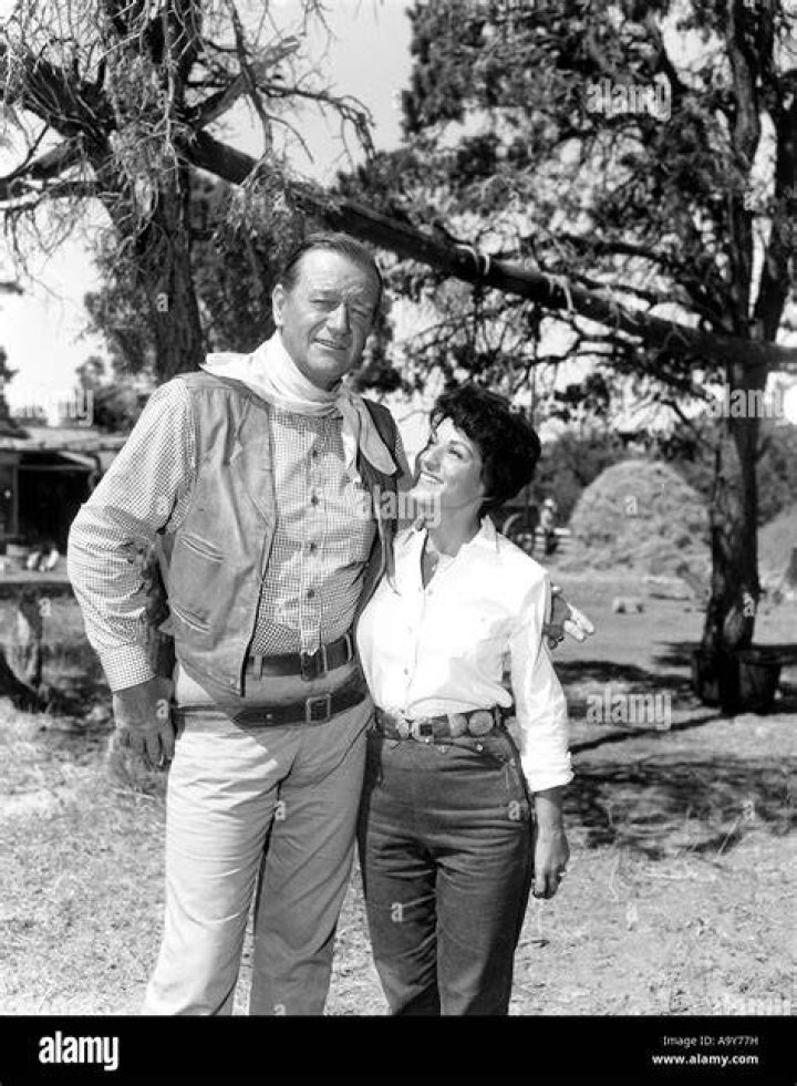 John Wayne and his wife Pilar attend a movie premiere in November