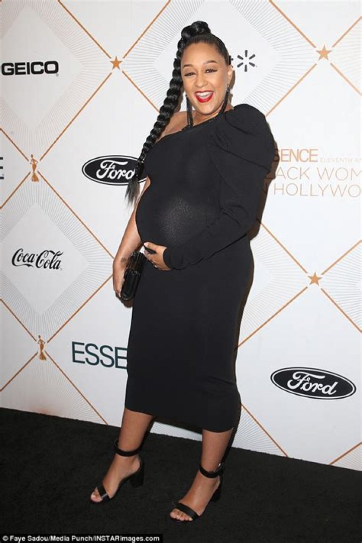 Pregnant Tia Mowry dons asymmetrical offtheshoulder dress Daily